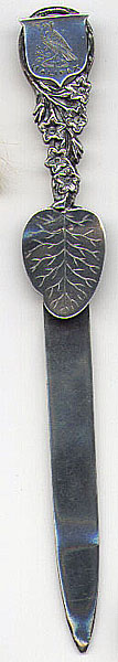 This bookmark is Canadian, made by J. Cornelius. It is marked J. Cornelius Sterling. On the front, the top has a shield with a bird and the word Halifax scribed under it. The small blade is a wide leaf. Date is 1900 - 1920.