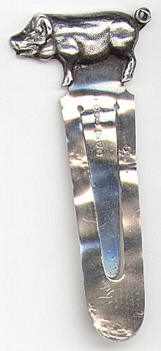 This bookmark is made in Chester England by Sampson Mordan & Co. It is marked 11 SM & Co. and the date letter C indicating 1903. It has a pig on the top.