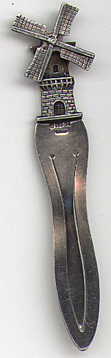 This bookmark is made in Holland. It is marked with some hallmarks which I cannot make out, 90 and Holland. It has a windmill on top that actually spins. Date is around 1920.