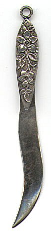 This bookmark is American made by A.F. Towle & Son Co. which later became Towle Silversmiths. It has the older mark on the back along with the word Sterling and the number 1. It has flowers and leaves on the top blade on the front. The date is around 1890.