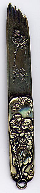 This bookmark is made in Japan between 1890 - 1910. It is made of brass with a picture of a man holding a staff with a monkey on his back in relief on the smaller blade and an engraved flower on the larger blade. This is similar to number 164. The dealer said she found this with a collection of Japanese page turners that she purchased. This looks like smaller versions of them.