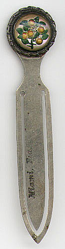 This bookmark was made in the US and says Miami, Fla. on the front blade. It is unmarked and the date is unknown. The top is a clear plastic covering plastic oranges and leaves.