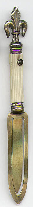 This bookmark is made in France and is a Stanhope or "peeper" bookmark. It is probably silver plate over brass on the fleur de lis on top and brass blades. It was made between 1890 and 1920. If you look through the "peep hole" you can see 6 photographs of different scenes. The center says "In Memory of Isle of Wight". The six photos are: "Ryde Pier", "The Green", "Osborne House", "Whippinghan Church", "SandDown Bay & Esplanade" and "West Cowes". It also says Made in France.