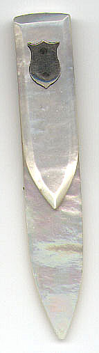 This bookmark was made in England by an unknown manufacturer. It is made of Mother of Pearl and has a silver shield on the top blade. The date is unknown.