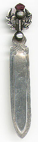 This bookmark was made in the US. It is marked Sterling and the manufacturer mark is very warn. It possibly says JC&S. It is a thistle with a purple stone on top. Date is 1900 - 1910.
