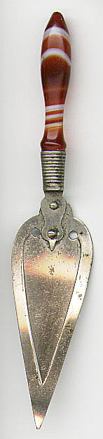 This bookmark was made in either England or Scotland. It is unmarked and is probably silver plate. It has an agate handle and is shaped like a trowel. Date is unknown.