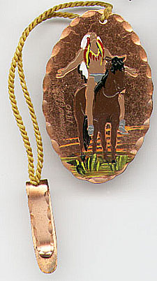 This bookmark was American made. It is made of copper and has an enamel painted Indian sitting on a horse and looking up at the sky. It is inscribed "Pomona Fair 1940" and was a souvenir of that Pomona, California fair.