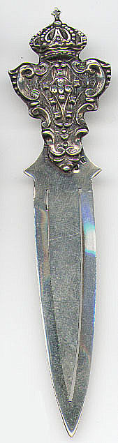 This bookmark was made in France. It has two French marks but they are too small to make out. It was probably made after 1940. The top of bookmark is a crown on top of a fancy shield.