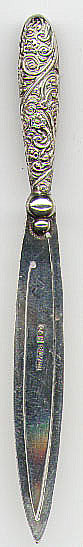 This bookmark is made in England and has the makers hallmark of C&N. It is marked Silver after the hallmark (not Sterling). The top is an ornate flowery handle.