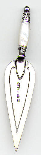 This bookmark is made in England in 1887. The manufacturer is A&L and it is from Birmingham. It is in the shape of a trowl with a silver and mother of pearl handle.