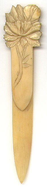 This bookmark is made of ivory or bone with a carved flower on top. The top blade has a stem etched in it. The date of the bookmark is unknown and was probably made in the US.