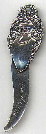 This bookmark is made in the US. It is marked Tiffany and Co. Sterling but was probably made by another company for Tiffany. The top is a bunch of intertwined feathers and leaves. The bottom blade is inscribed Philopena. The date is 1900 - 1910.