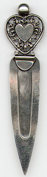 This bookmark is American made by The Napier Company. It is marked Napier Sterling. The top of the bookmark is in the shape of heart. The date is sometime after 1922.