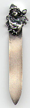 This bookmark is made in the US by the Metallugic Art Co. in Baltimore, Maryland. It was made between 1896 - 1901. It is marked with the manufacturers mark and Sterling. The top part is a small cherub.
