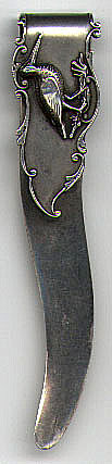 This bookmark is made in the US by an unknown manufacturer. It is marked sterling on the back. The front blade has a picture of some type of bird. The manufacturer is probably the same one that manufactured number 234 for Tiffany and Co. by the shape of the blade and the font of the world sterling on the back. The shape of the blades are identical to number 130. The date is 1900 - 1910.