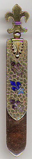 This bookmark was made in France. It is marked on the top blade and on the back of the bottom blade with a lozenge. Inside the lozenge are the letters J and H separated by some kind of animal. The top blade looks to be either gold plate or brass with enamel fleur de lis'. The longer bottom blade looks to be rose gold in color but the metal is unknown. The top is a fleur de lis.