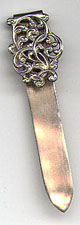This bookmark is American made by Unger Brothers. The mark is an interlaced U and B. It has an art nouveau design on top with a plain silver blade.  
