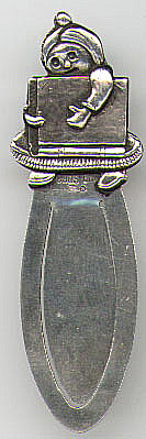 This bookmark is Scandinavian with Swedish import marks. It is marked 830S, CMC and the three crowns import mark and the S import mark. The top of the mark is in the shape of a girl carrying a book. The date is probably 1900 - 1910.