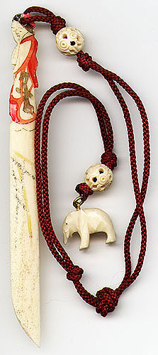 This bookmark is made in Hong Kong sometime in the 1930's or 1940's. It is in the shape of a woman on the top with two carved beads and a carved elephant at the end of the cord. It is made of either bone or ivory.