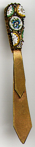 This bookmark was made in Italy sometime between 1910 and 1930. It has some sort of mark on the back but it is not ledgible. The top is made of mosaic glass pieces. The rest is made of brass.