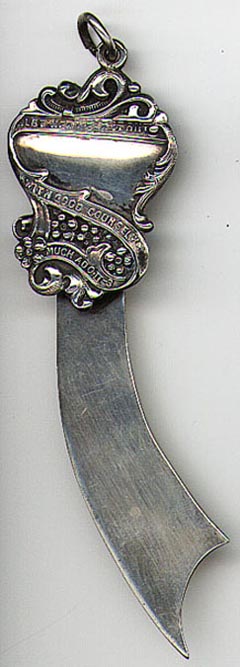 This bookmark was made in the US by an unknown manufacturer. It is marked Sterling 1601 on the back. The top blade is a shield that says "..Let her wear it out with good counsel.., Much Ado, II-3" It is a quote from the Shakespeare play, "Much Ado About Nothing" act II, scene 3. It was probably used in a law book in a law library. The date is 1900 - 1910.