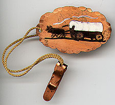 This bookmark was made in New Mexico sometime in the 1940's. It is made of copper and has a hand painted covered wagon being pulled by two oxen.