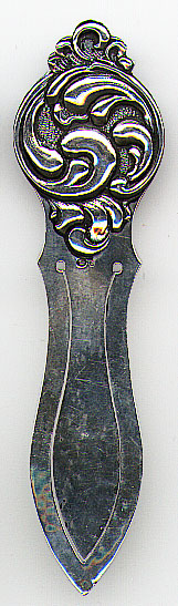 This bookmark was made in Sweden. It is marked with the Swedish import mark and the letter S. The top is an art nouveau design and the bottom blades are hand hammered. The date is 1900 - 1920.