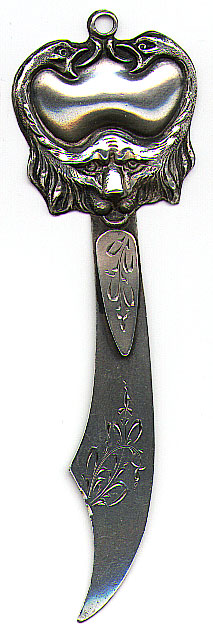 This bookmark was made in the US by an unknown manufacturer. It is marked Sterling 925/1000 on the back. The top part of the bookmark is the face of a lion with a goose head protruding from each side of the face. the blades have some etched flowers. Date is 1900 - 1910.