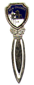 This bookmark was made in the US as a souvenir for New Orleans, LA. It is made of some kind of metal with blue and white enamel on top. The top is in the shape of a shield with the words New Orleans LA and a lion and a tower. Date is unknown.