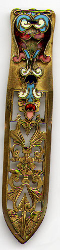 This bookmark was made in Austria. It is gilt bronze with champleve enamel work on the top blade. The bottom blade is a cutout design of flowers and leaves. The date is 1890 - 1900.