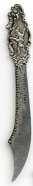 This bookmark was made in the US by an unknown manufacturer. It is marked Warranted Sterling Silver and Compliments of Eugene Tompkins. The top is a picture of a man riding a horse. The top blade says "Souvenir of the 100th Performance of Burmah at the Boston Theater". The date is 1900 - 1910.