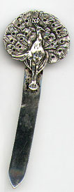 This bookmark was made in the US by Unger Brothers between 1904 and 1914. It is marked with the interlaced U and B hallmark and Sterling 925 Fine. The top is a peacock whose legs form the top blade.
