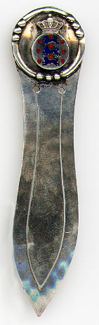 This bookmark was made in Norway. It is marked BH 830S and has both blades hand hammered. The top has a royal crest in enamel. The date is 1920 - 1930.