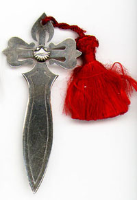 This bookmark is from Galicia in north west Spain. It is marked MALDE with two hallmarks for the manufacturer that still exists in La Corua. It is a representation of the cross of Santiago (St. James). The scallop shell in the center of the cross is associated with the pilgrims that visit the St. James's shrine in Santiago de Compostela. The date is unknown.
