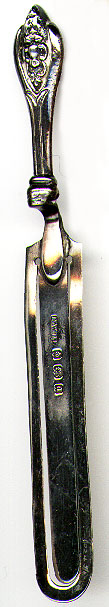 This bookmark is made in Birmingham, England in 1903. It is marked with the standard Birmingham marks and the "d" date letter. The manufacturer was H.W. Ltd. It is in the shape of a piece of serving ware with a victorian design on the handle.