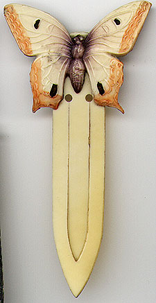 This bookmark was made in the US by an unknown manufacturer. It is made of celluloid and is in the shape of a butterfly.