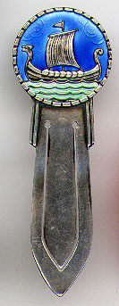 This bookmark was made in Norway. It is marked with a hallmark, 925S and the letter N enclosed in a square. The top is a Norse ship with enameled sky and sea. Date is unknown.