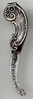 This bookmark was made in the US by Dominick and Haff, Inc. between 1889 and 1910. It is marked with the manufacturers hallmark, sterling and the number 22. The larger blade is marked St. Augustine. The smaller top blade has an art nouveau design with flowers.