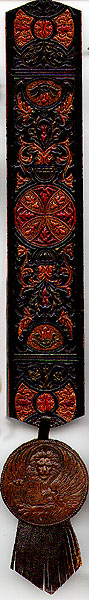 This bookmark was made in Italy between 1890 and 1910. It is all hand carved leather and is marked "Made in Italy" on the back. The round medallion on the bottom is a winged lion holding a book which says "PAX TIBI MAR CE" and "EVA NGE ESTA MEUS".