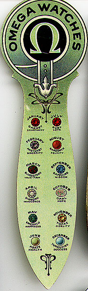 This bookmark was made in the US as an advertisment for the Omega Watch company. It is made of celluloid and was manufactured between 1910 and 1920. It has the 12 months with pictures of birthstones for each month.