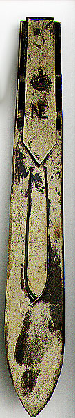 This bookmark was made in a European country between 1910 and 1930. It is unmarked except for the design on top which is a crown and the letters NE. The material it is made of is some kind of metal.  