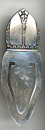 This bookmark was made in the US by Frank Whitting. It is marked only sterling. The top has some flowers on it. The date is 1930 - 1940.