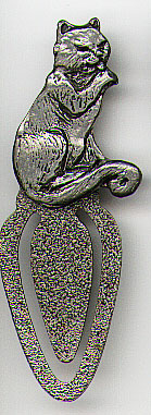 This bookmark is pewter and was made in the US in 1983. It is a cat licking his paw. The back is signed "CAT Karpita 1983 BBTC Pewter".