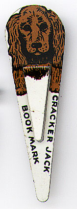This bookmark was made in the US for Cracker Jack. It is one of four bookmarks in a series showing different dogs. This one is a picture of a spaniel. It is made of tin and was manufactured in the 1940's.  