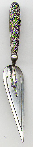 This bookmark was made in Birmingham, England in 1900. It is marked with the Birmingham marks and the letter "a" for the year 1900. It is in the shape of a trowel with a fancy victorian handle.