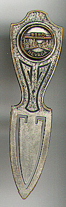 This bookmark was made in the US by an unknown manufacturer. It is a souvenir bookmark for Reno, Nevada and is made of silver plate over brass. The top has a medalion of Reno, Nevada. The date is 1940 - 1950.
