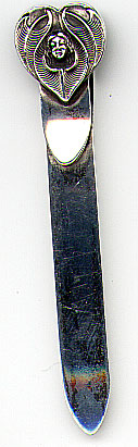 This bookmark was made in the US by an unknown manufacturer. It is marked only sterling on the back. The top is a figural of a heart with a womans head in the center. The date is 1900 - 1910.