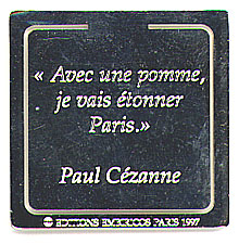 This bookmark was made in France in 1997. It is silver plate and inscribed, "Avec une pomme, je vais etonner Paris", a quote from Paul Cezanne which translates to "With an apple I shall astound Paris." It is marked Editions Basia Embiricos Paris 1997.
