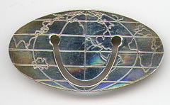 This bookmark was made in the US by Tiffany and Co. It is marked Tiffany & Co. 925 Sterling &copy;. It is a world map in an oval shape. The date is 1980 - 1990