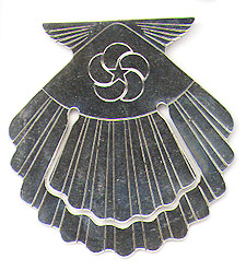 This bookmark was made in the US by Tiffany & Co. for American Hawaiian Cruises. It is marked Sterling Tiffany & Co. and is engraved American Hawaiian Cruises. It is in the shape of a scallop shell. The date is 1990 - 1998.